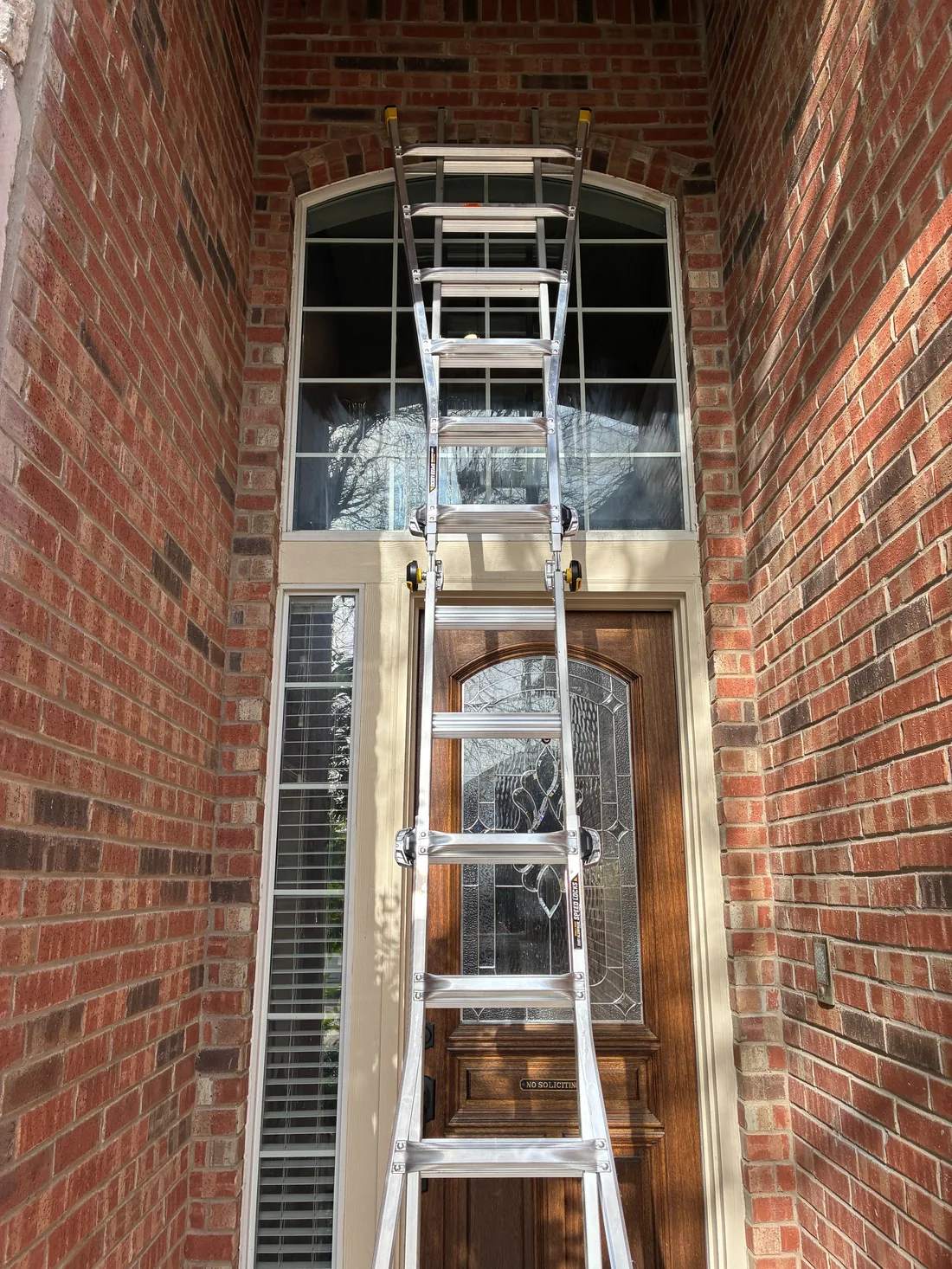 Tall entryway window cleaning with ladder in McKinney, TX